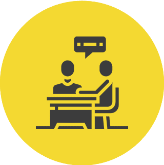 Two people talking at a table.