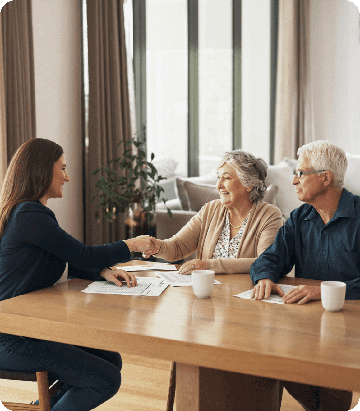 Meeting between woman and elderly couple, handshake.